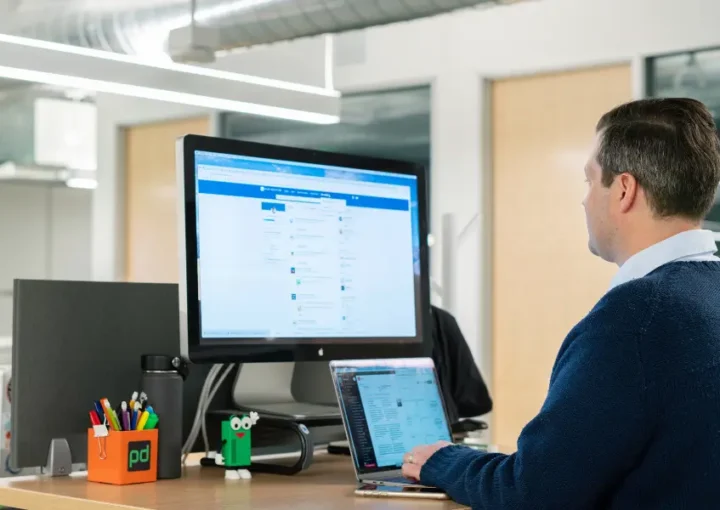 A person using a LinkedIn comapny page in an office setting