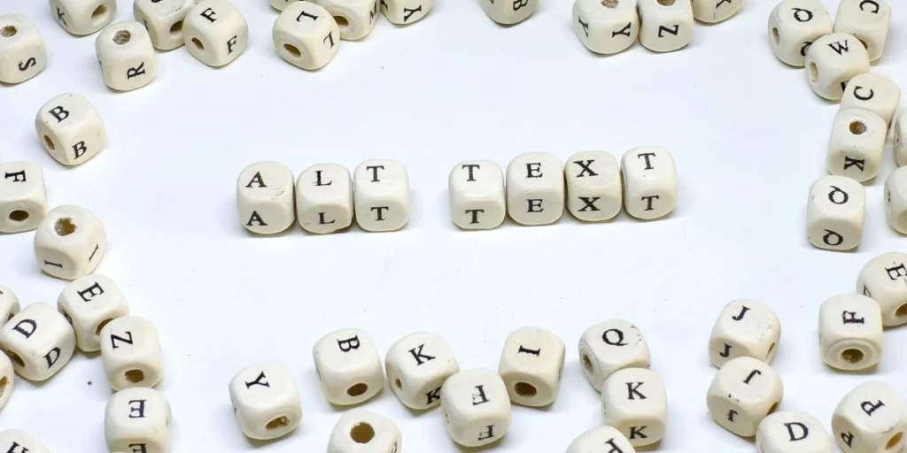 In the centre, seven dice with letters spelling out "Alt Text", and various other dice around the edges with different letters lay scattered around.