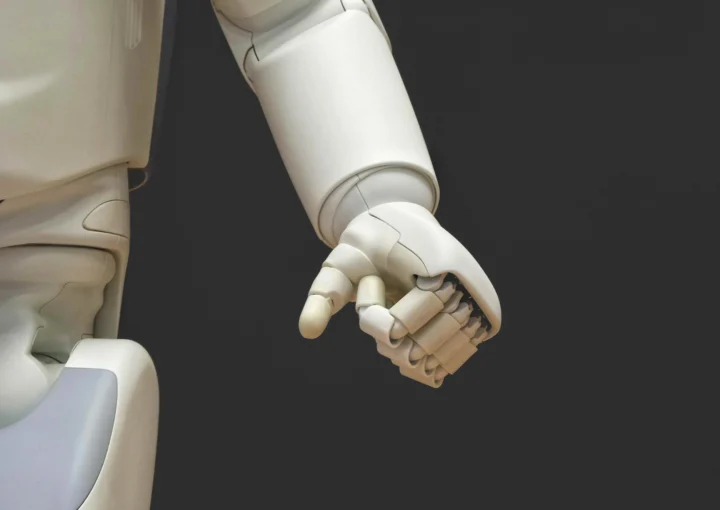 a white robot arm with the hand in a fist position