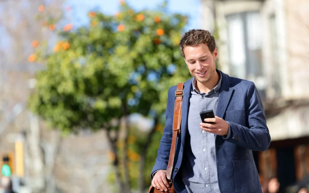 A professional using a smart phone outside